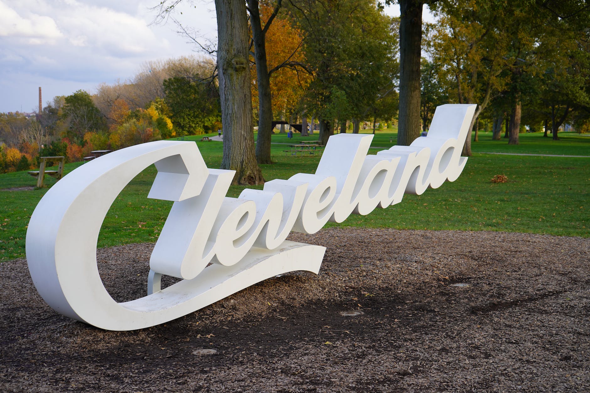 white cleveland script sign in a park